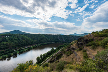 Obraz na płótnie Canvas Labie river with hills of Ceske stredohori mountains above from Tri krize viewpoint in Czech republic