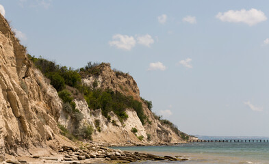 Fototapeta na wymiar Bulgarian resort-Balchik. Rocky cliffs of sedimentary rock on the Black Sea coast.