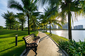 Public green park with modern blocks of flats and blue sky with white clouds in Vietnam