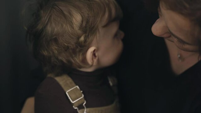 Mom wipes her little son's face with a damp cloth. Maternal care and sensitivity