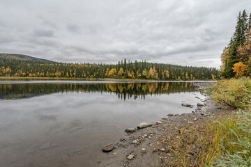 Fototapeta na wymiar camping caravan near river autumn fall landscape along Ammarnas National Park in Lapland Sweden