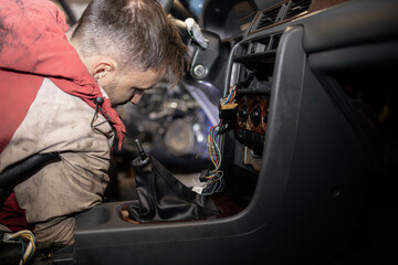 Fototapeta na wymiar disassemble the center console of the car torpedo for interior detailing and repair.