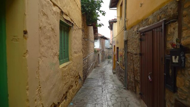 Narrow Street in a picturesque Kyriotissa quarter with tall buildings