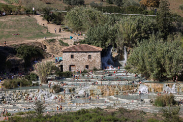   People are bathing in the hot springs of Saturnia Therme, Saturnia, Tuscany, Italy