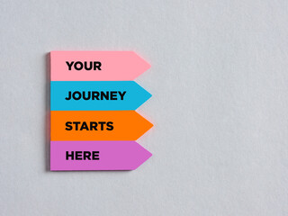 Colorful arrow shaped stickers with the message your journey starts here.