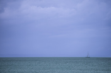 Fototapeta na wymiar Sailboat seen sailing on ocean