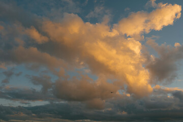 Fototapeta na wymiar Dramatic fiery clouds at sunset, glowing in vibrant orange. Ceuta, Spain