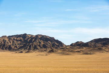 Kazakhstan landscape. Dry grass and mountains