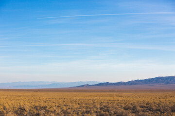 Obraz premium Kazakhstan steppe landscape. Dry grass and mountains