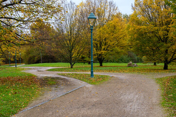 Path in a park around a lamp with a shortcut showing preferred way through