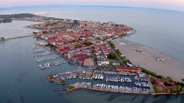 4k drone forward video (Ultra High Definition) of Grado port, small town located between Venice and Trieste. Magnificent evening seascape of Adriatic sea.