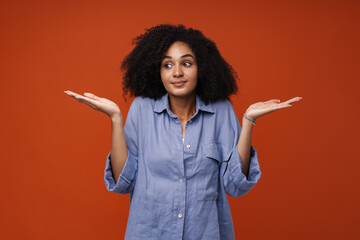 Young middle-eastern woman with curly hair throwing her arms aside