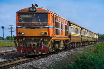 Naklejka premium Passenger train by diesel locomotive on the railway.
