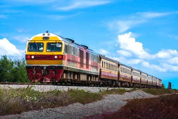 Plakat Passenger train by diesel locomotive on the railway.