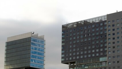 Fototapeta premium Rectangular buildings with the sky in the background. Contemporary gray buildings