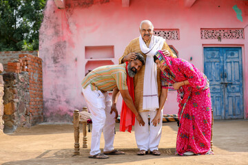 Old man blessing to son and daughter in law