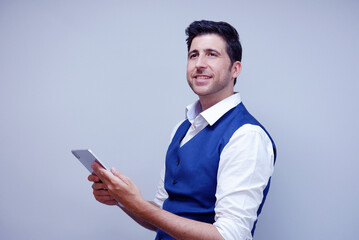 Smiling businessman using tablet on a white background.