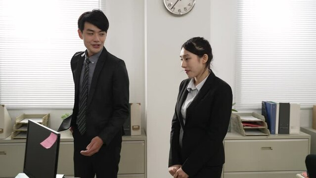 slow motion of male team leader introducing trainee to his female business partner, who smiles and welcomes the newcomer in office. friendly coworker and workplace concept