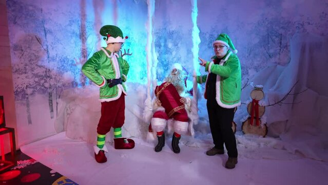 Santa Claus and elves have fun dancing