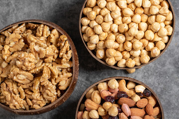 Walnuts, pistachios, hazelnuts and mixed nuts in a bowl on a dark background. Close up