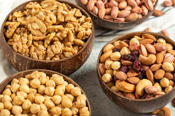 Walnuts, pistachios, hazelnuts and mixed nuts in a bowl on a gray background. Close up