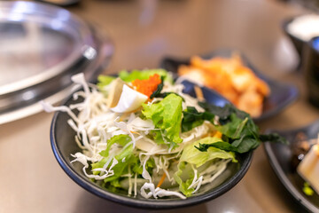 Healthy hearty salad of cabbage,  eggs, sea weed, close-up in a bowl on the table