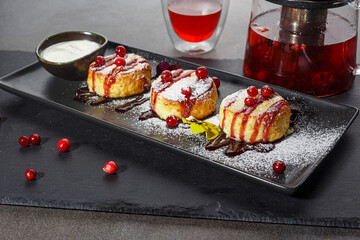 Cheesecream pancakes or Syrniki with berries and sour cream. Russian and Ucranian cuisine. Healthy, delicious breakfast, dessert