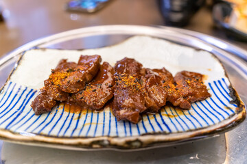 Close up soy sauce grills beef on white plate, traditional Cuisine from Japanese restaurant