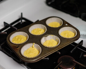 tray of regular cornbread batter spooned into cupcake papers