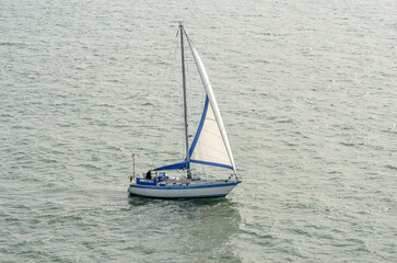 Sailboat sailing on the ocean seen from the sky