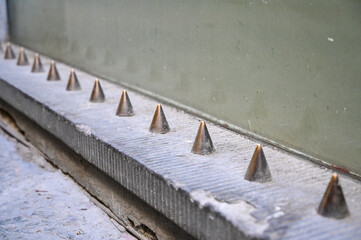 Hostile architecture. Metal spikes designed to prevent homeless people to sleep in public places. Defensive architecture.