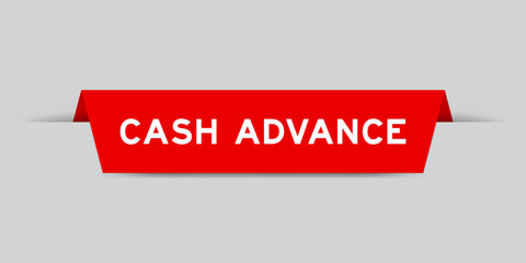 Red color inserted label with word cash advance on gray background