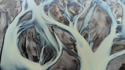 Glacial rivers from above. Aerial photograph of the river streams from Icelandic glaciers. Beautiful art of the Mother nature created in Iceland. Wallpaper background 