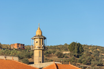 Fototapeta na wymiar Low-angle view of the masjid minaret in the village. 