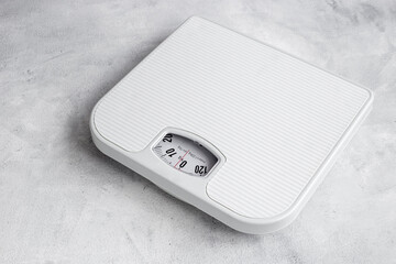 White weight scales on the floor. Weight measurement and loss concept