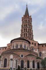 Fototapeta na wymiar Vertical landscape view of the apse and bell tower of ancient landmark St Sernin basilica, Toulouse, France