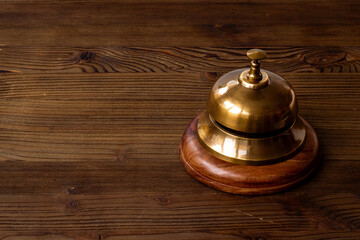 Fototapeta na wymiar Close up of hotel golden service bell. Attention concept