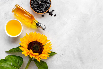 Yellow sunflowers with cooking oil and black seeds. Food background