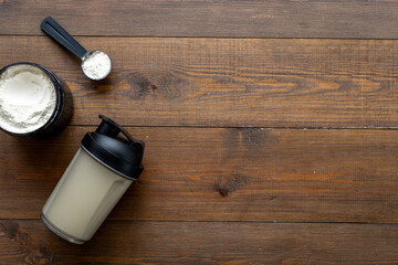 Whey protein powder in jar with shaker for mixing. Fitness and gym diet