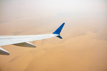 a plane flying over the desert 