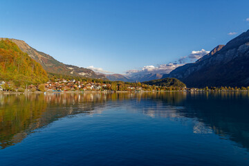 Fototapeta premium Beautiful scenic autumn landscape with Lake Brienz in the foreground at Bernese Oberland, Canton Bern, on a sunny autumn afternoon. Photo taken October 18th, 2022, Brienz, Switzerland.