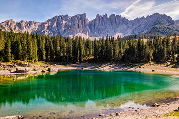 Naklejka na ściany i meble Incredible panoramic view of the Lake Carezza (Italian: Lago di Carezza, German: Karersee), a small alpine lake in the Dolomites in South Tyrol