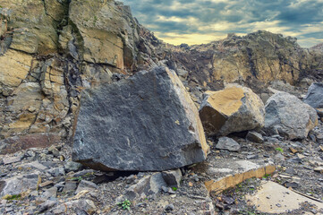 Huge stones in an open stone quarry. Rocky desert, gloomy landscape