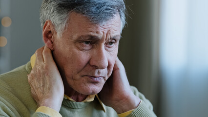 Sad old caucasian man suffer from neck pain 60s upset male tired grandfather feel ache in spine hurt discomfort tension rubbing muscle from uncomfortable posture osteochondrosis retired symptoms