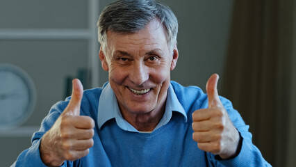 Portrait of happy mature elderly man showing two thumbs up smiling pensioner looking at camera demonstrate affirmative supportive gesture positive grandfather satisfied with service approve concept