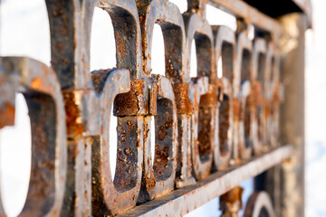 Obraz na płótnie Canvas An old rusty iron fence on the fence.