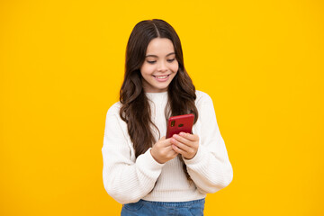 Portrait of cute teenage girl using mobile phone, chatting on web, typing sms message. Mobile app for smartphone. Children lifestyle concept. Mock up copy space. Happy face.