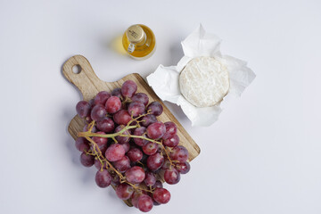 fresh goat cheese and grape fruit on wooden background.