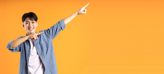 image of young asian man posing on orange background