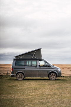 Dirty car parked on grassy meadow